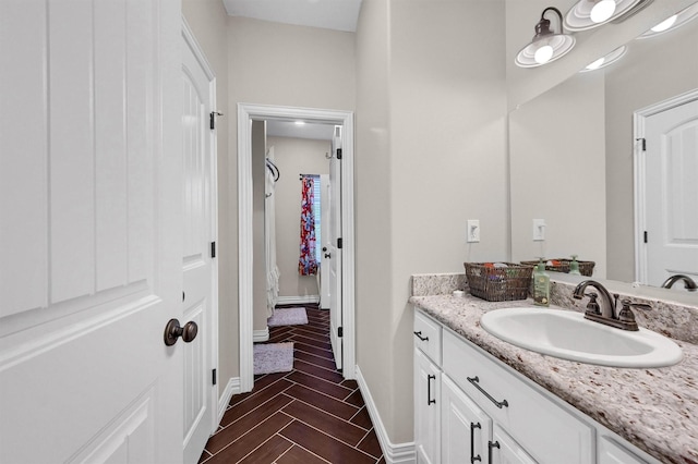 bathroom featuring baseboards and vanity