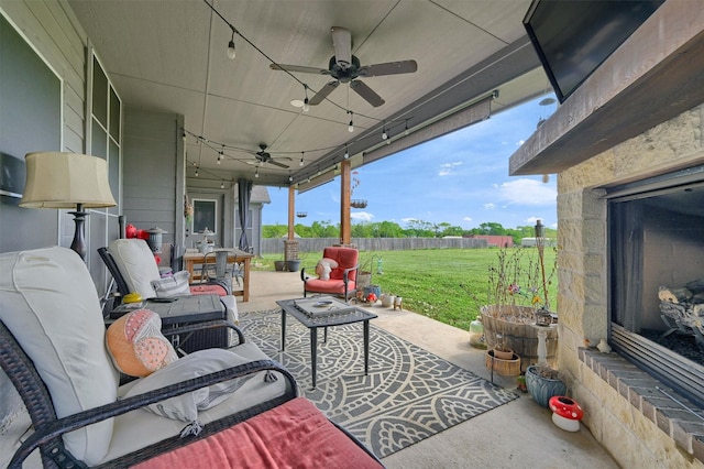 view of patio featuring fence, ceiling fan, and outdoor lounge area