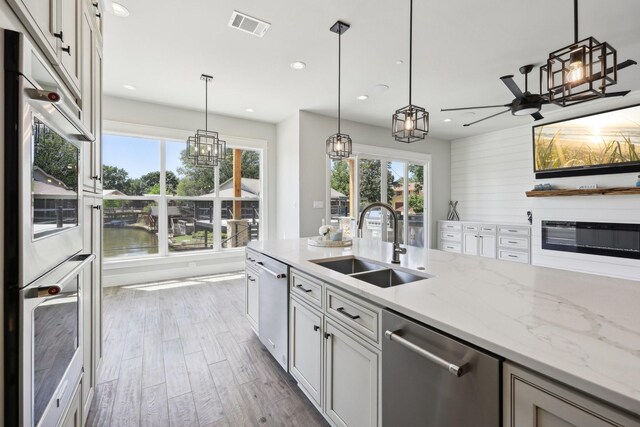 kitchen with stainless steel dishwasher, visible vents, a sink, and recessed lighting