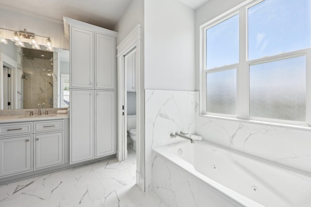 bathroom with a tub with jets, a marble finish shower, vanity, marble finish floor, and toilet
