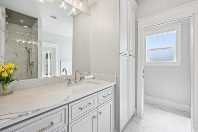 bathroom featuring marble finish floor, visible vents, vanity, a marble finish shower, and baseboards