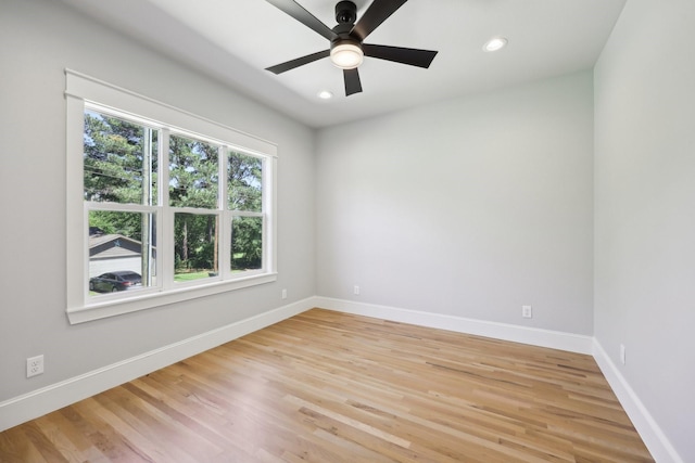 empty room featuring recessed lighting, light wood-style flooring, and baseboards
