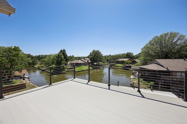 view of patio / terrace featuring a water view and a balcony