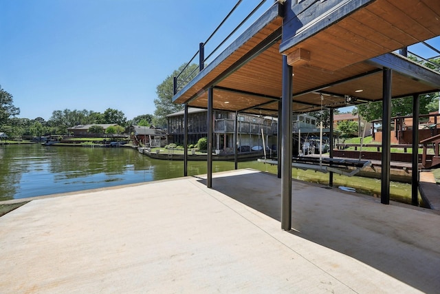 view of dock with a patio area and a water view
