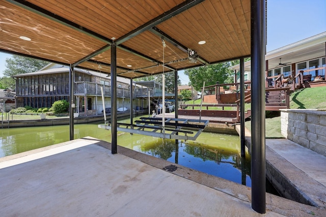 view of dock featuring boat lift and a water view
