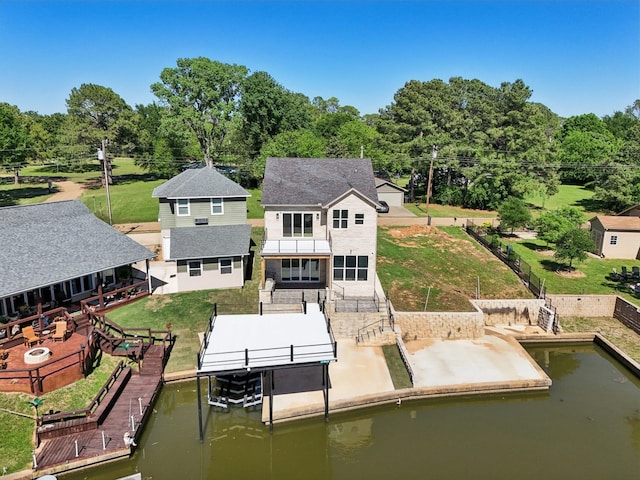 rear view of property featuring a patio, a fenced backyard, and boat lift