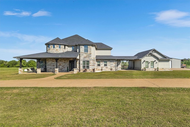 view of front facade with stone siding and a front yard