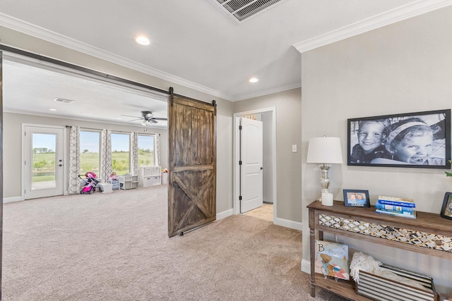 recreation room with a barn door, carpet floors, visible vents, and baseboards