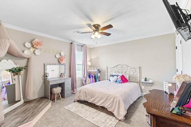 carpeted bedroom with a ceiling fan, crown molding, and visible vents
