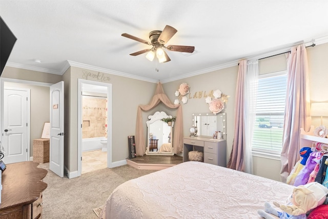 bedroom with carpet, ensuite bath, crown molding, baseboards, and ceiling fan
