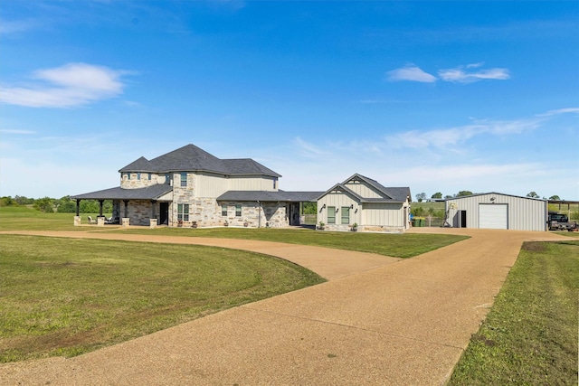 view of front of home with a detached garage, driveway, board and batten siding, and a front lawn