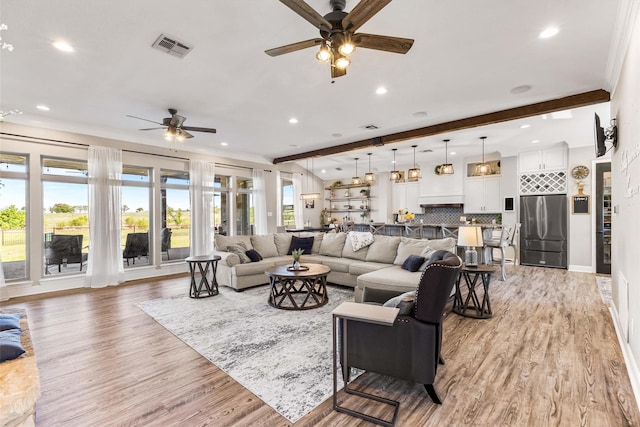 living room with ceiling fan, visible vents, and recessed lighting