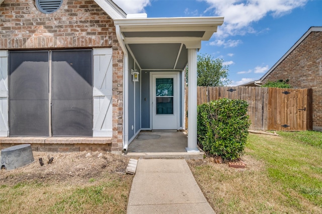 4430 Chapman St, The Colony, TX 75056 - view of exterior entry with fence, a lawn, and stone siding