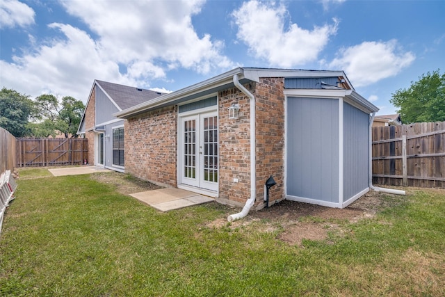 4430 Chapman St, The Colony, TX 75056 - rear view of house featuring a fenced backyard, french doors, a yard, and brick siding