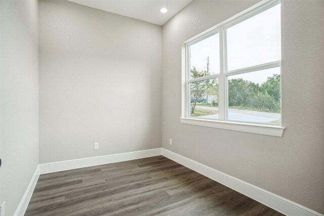 unfurnished room featuring recessed lighting, dark wood finished floors, and baseboards