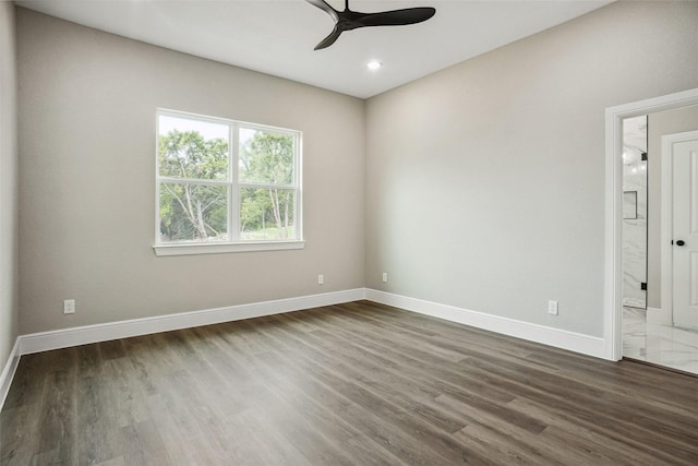 empty room featuring baseboards, a ceiling fan, dark wood-style floors, and recessed lighting