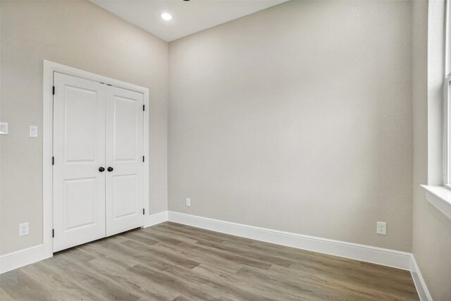 unfurnished room with recessed lighting, wood finished floors, baseboards, and ceiling fan