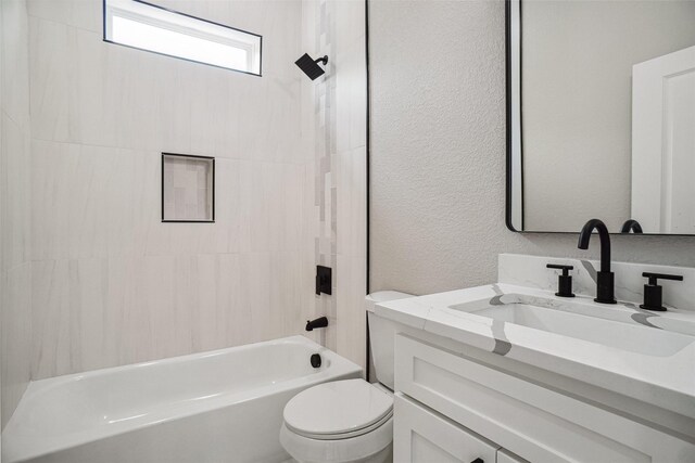 bathroom with a textured wall, toilet, vanity, and bathing tub / shower combination
