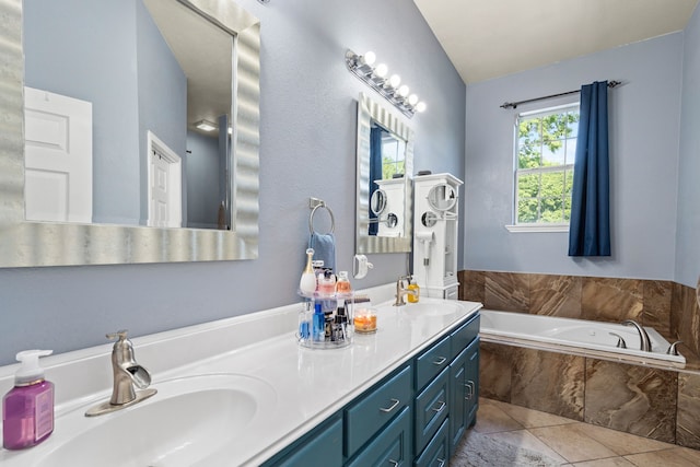 full bathroom with vaulted ceiling, double vanity, a garden tub, and a sink