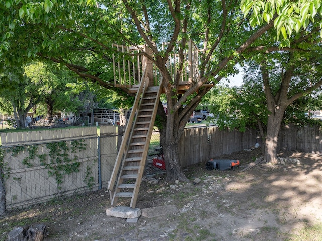 view of yard featuring stairs and fence private yard