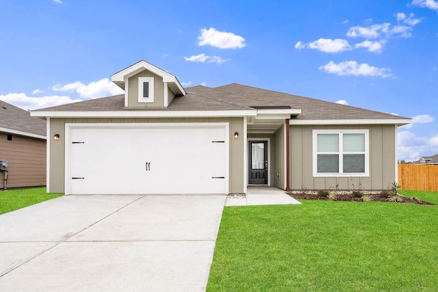 view of front of home featuring driveway, board and batten siding, fence, a front yard, and a garage