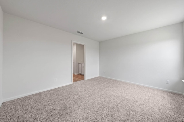 unfurnished room with light colored carpet, baseboards, visible vents, and recessed lighting