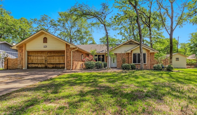single story home with concrete driveway, brick siding, a front yard, and a garage