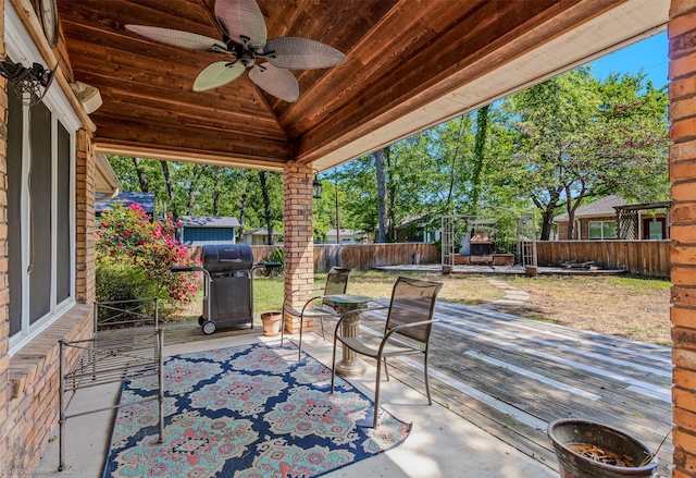 view of patio with ceiling fan, a fenced backyard, a wooden deck, and area for grilling