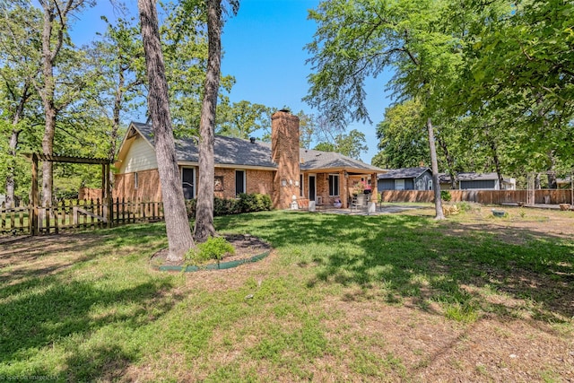 back of property featuring a fenced backyard, brick siding, a yard, and a patio
