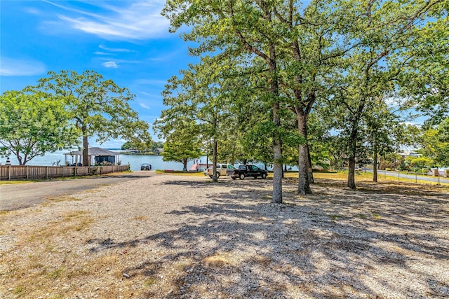 view of yard with fence and a water view