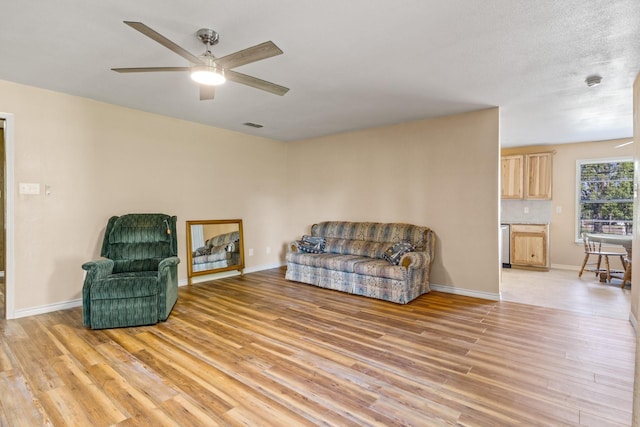 314 Cedar, Mount Pleasant, TX 75455 - sitting room with light wood-style flooring, baseboards, and ceiling fan
