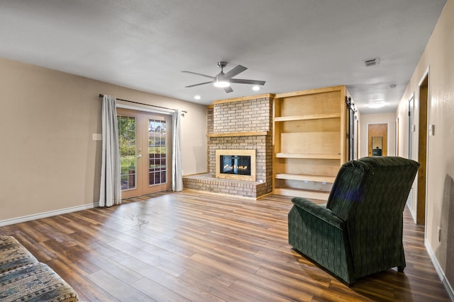 314 Cedar, Mount Pleasant, TX 75455 - living room with a fireplace, wood finished floors, a ceiling fan, and baseboards