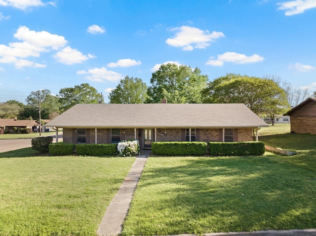 314 Cedar, Mount Pleasant, TX 75455 - ranch-style home featuring brick siding, a chimney, a front lawn, and a shingled roof