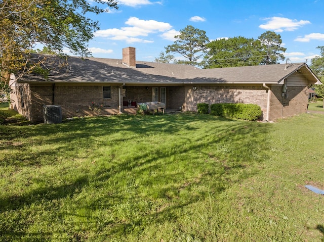 314 Cedar, Mount Pleasant, TX 75455 - back of property featuring a chimney, brick siding, a yard, and cooling unit