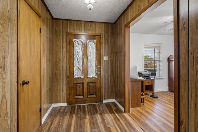 314 Cedar, Mount Pleasant, TX 75455 - entryway with wood walls, baseboards, wood finished floors, and a textured ceiling