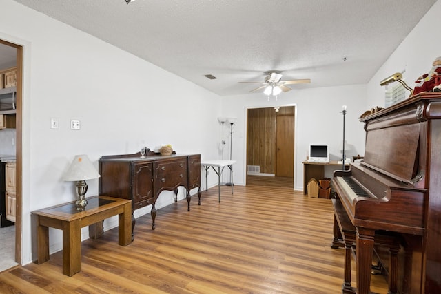 314 Cedar, Mount Pleasant, TX 75455 - living area featuring wood finished floors, a textured ceiling, a ceiling fan, and visible vents