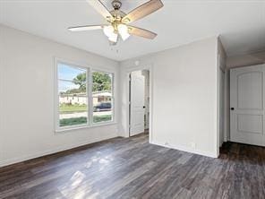 empty room featuring baseboards, a ceiling fan, and wood finished floors