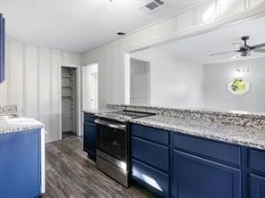kitchen with electric stove, blue cabinetry, dark wood-style floors, and light stone counters