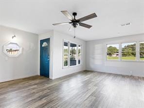 unfurnished living room featuring wood finished floors, visible vents, and ceiling fan