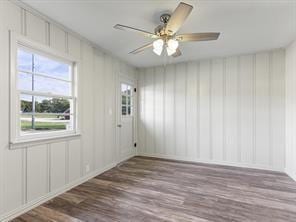 spare room with baseboards, a ceiling fan, and wood finished floors