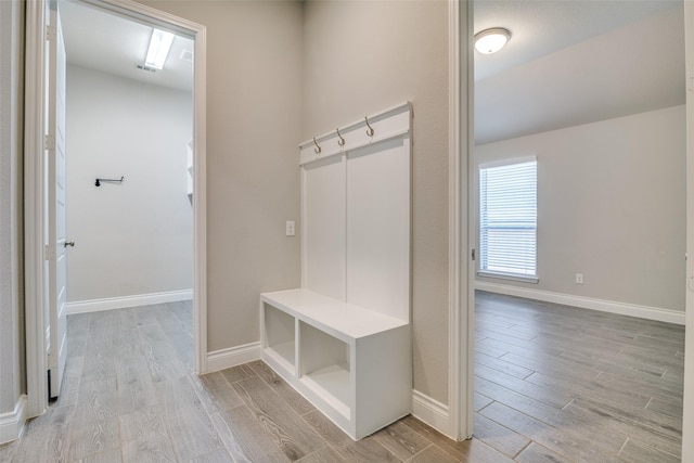 mudroom with baseboards and light wood-type flooring