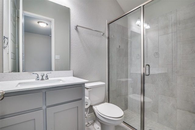 full bathroom with a textured wall, vanity, a shower stall, and toilet