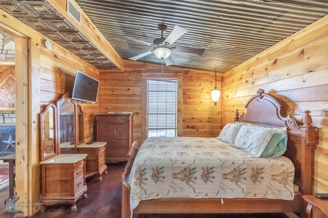 bedroom featuring visible vents and wood walls