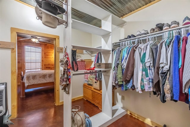 spacious closet with heating unit and a ceiling fan