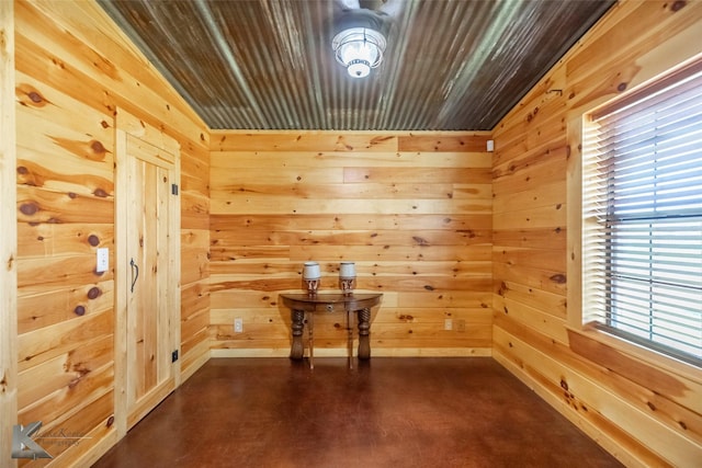 interior space featuring wood walls and concrete flooring