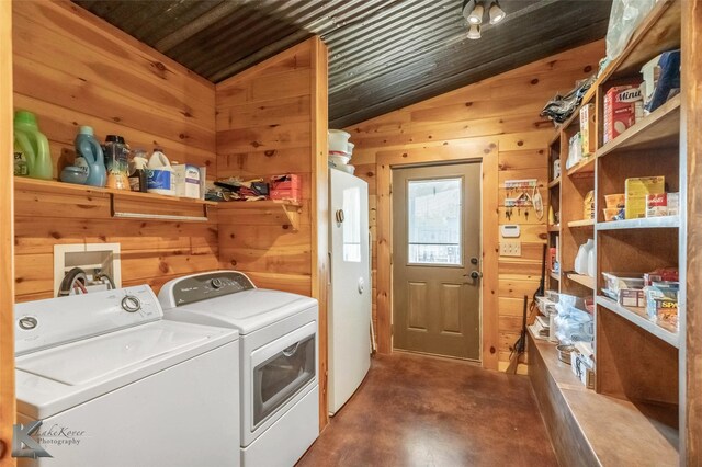 laundry room featuring wooden walls, laundry area, wood ceiling, and separate washer and dryer