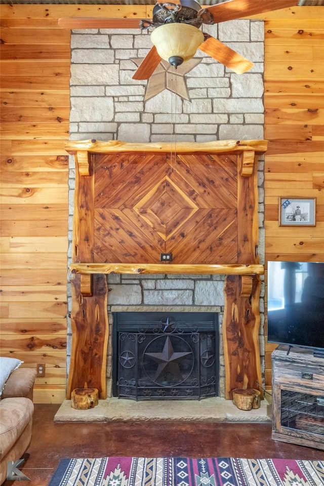 living room with wooden walls and a fireplace