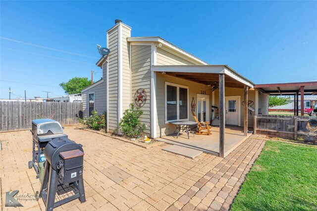 view of patio with a fenced backyard, ceiling fan, and grilling area