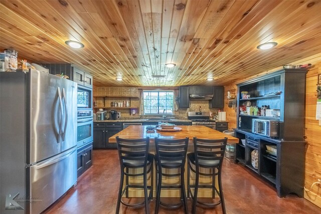 kitchen with open shelves, under cabinet range hood, concrete floors, and appliances with stainless steel finishes