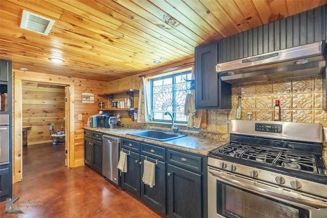 kitchen featuring stainless steel appliances, a sink, finished concrete flooring, decorative backsplash, and under cabinet range hood